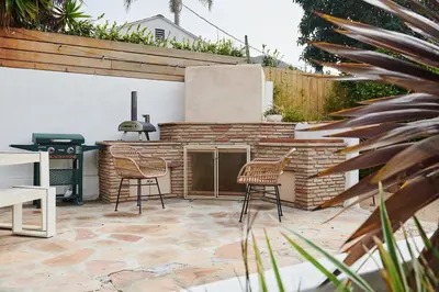 a patio with two chairs and a grill at LA Oasis with Private Yard 10 min to Beach LAX 405 in Los Angeles