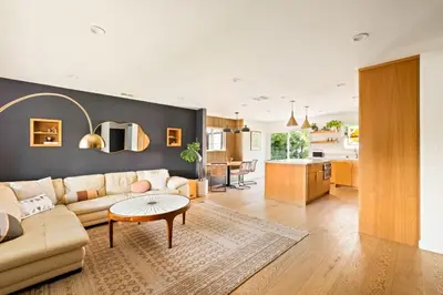 a living room with a couch and a table and a kitchen at LA Oasis with Private Yard 10 min to Beach LAX 405 in Los Angeles