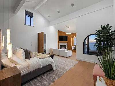 a bedroom with a large bed and a living room at Villa Costera in Malibu Beach