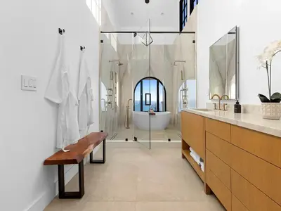 a bathroom with a tub and a toilet and a sink at Villa Costera in Malibu Beach