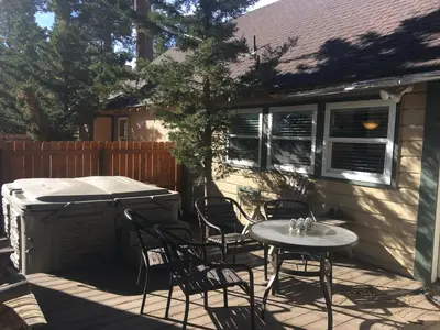 a patio with a table and chairs and a barbecue at Bear Creek Resort in Big Bear Lake