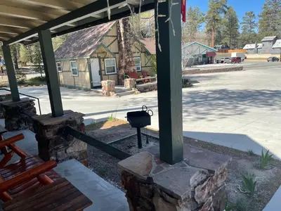 a stone pillar with a grill in front of a building at Bear Creek Resort in Big Bear Lake