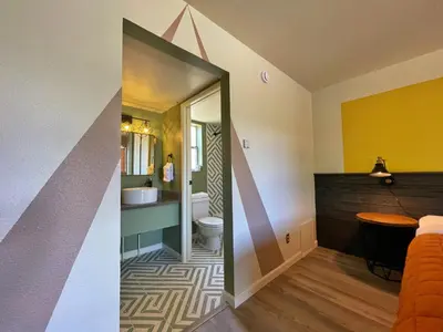 a bathroom with a sink and a toilet in a room at Sessions Retreat & Hotel in Big Bear Lake