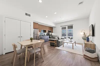 a kitchen and living room with a table and chairs at Stylish Condo Mins to Shoreline in Long Beach