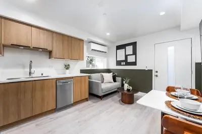 a kitchen and living room with a couch and a table at Cozy LA Getaway Fast Wi-Fi and Smart TV in Los Angeles