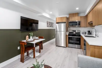 a kitchen with a small table and a refrigerator at Cozy LA Getaway Fast Wi-Fi and Smart TV in Los Angeles