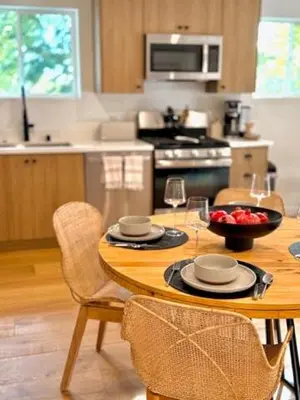 a kitchen with a table with a bowl of fruit on it at Hillside Haven - Boutique Spanish Escape in Ojai