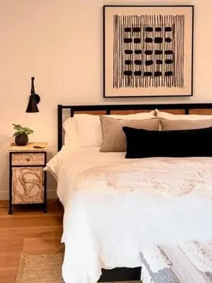 a bedroom with a large white bed and a night stand at Hillside Haven - Boutique Spanish Escape in Ojai