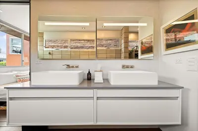 a bathroom with two sinks and a mirror at Hip Venice 5BR 4BA Home w Rooftop and Steps to the Beach in Los Angeles