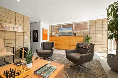 a living room with two chairs and a table and chessboard at Hip Venice 5BR 4BA Home w Rooftop and Steps to the Beach in Los Angeles
