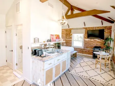 a kitchen with a sink and a living room at Venice V Hotel in Los Angeles