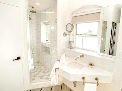 a white bathroom with a sink and a shower at Venice V Hotel in Los Angeles
