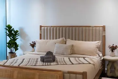 a bedroom with a large bed with a wooden headboard at The W Hotel Residence With Roof Top Pool, Gym Plus 2 Free Valet Parking spaces in Los Angeles