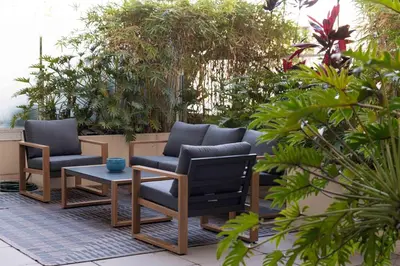 a patio with two chairs and a table and plants at The W Hotel Residence With Roof Top Pool, Gym Plus 2 Free Valet Parking spaces in Los Angeles