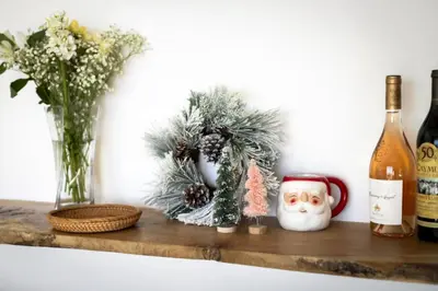 a shelf with a christmas wreath and a bottle of wine at Malibu Breeze in Malibu Beach