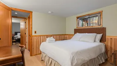 a bedroom with a bed and a desk and a window at 5BDR Hot Tub Deck Firepit Mins to Village Lake The Hilltop by AvantStay in Lake Arrowhead