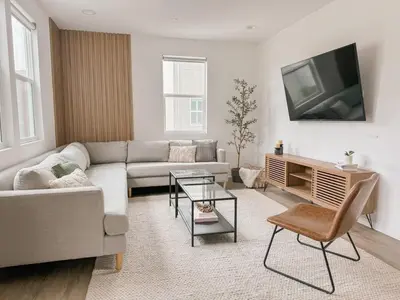 a living room with a couch and a tv at Central, Urban Townhouse with Private Roof Deck in Garden Grove