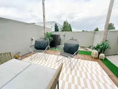 two chairs and a table on a patio at Central, Urban Townhouse with Private Roof Deck in Garden Grove