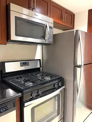 a kitchen with a stove and a microwave at Downtown LA Urban Escape in Los Angeles