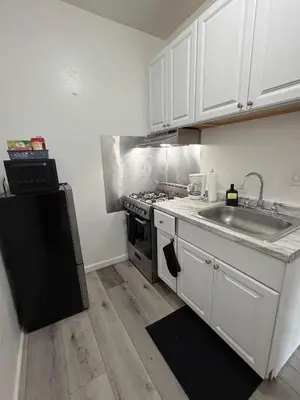 a kitchen with a sink and a stove at Westlake MacArthur Park Studio in Los Angeles