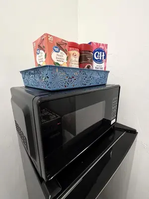 a microwave with a basket on top of it at Westlake MacArthur Park Studio in Los Angeles