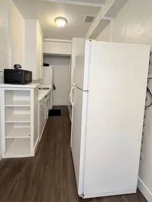 a kitchen with a white refrigerator in a room at Wilshire Center K-Town Studio in Los Angeles