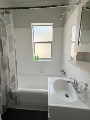 a white bathroom with a sink and a window at Wilshire Center K-Town Studio in Los Angeles
