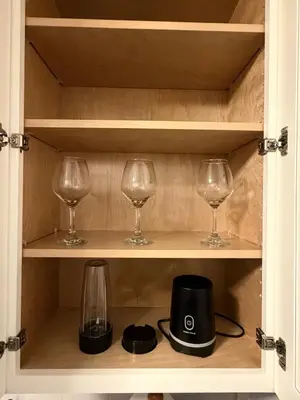 a cupboard with two wine glasses and a blender at Steps from The Hollywood Walk of Fame in Los Angeles