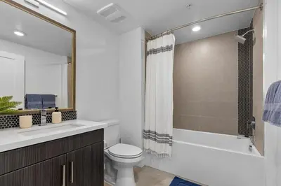 a bathroom with a toilet and a sink and a shower at Amethyst Sky Loft - Elevated Two-Story Waterfront in Los Angeles