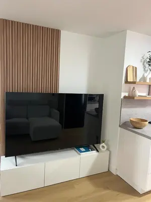 a living room with a tv on a white cabinet at East Hollywood Modern Spacious Bungalow in Los Angeles