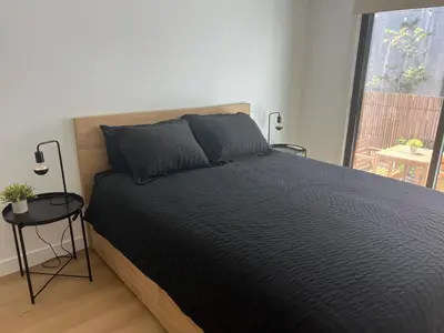 a bedroom with a large bed and a window at East Hollywood Modern Spacious Bungalow in Los Angeles
