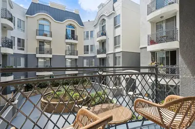 a balcony with two chairs and some buildings at Chic Marina Oasis 5 star Amenities Central in Los Angeles