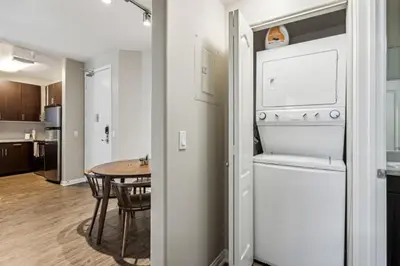 a kitchen and dining room with a table and a refrigerator at Chic Marina Oasis 5 star Amenities Central in Los Angeles