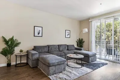 a living room with a gray couch and a table at Cozy Marina Hideaway Gym Pool & Spa Central in Los Angeles