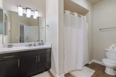 a bathroom with a sink and a toilet and a mirror at Cozy Marina Hideaway Gym Pool & Spa Central in Los Angeles