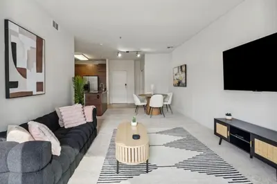 a living room with a couch and a flat screen tv at Modern Marina Sanctuary Central Pool Gym Spa in Los Angeles