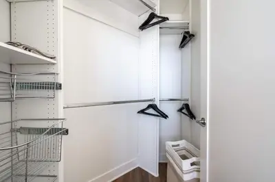 a walk in closet with white walls and a glass door at Sleek Marina Den Central Gym Pool King Bed in Los Angeles