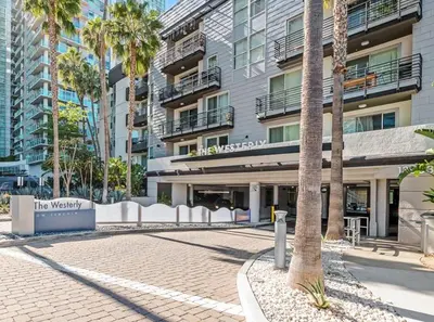 a building with a palm tree in front of it at Daybreak MDR in Los Angeles