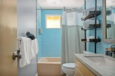 a bathroom with a shower and a toilet and a sink at Skiers Crest - Hot Tub, Yard, Near Lake & Slopes in Big Bear Lake