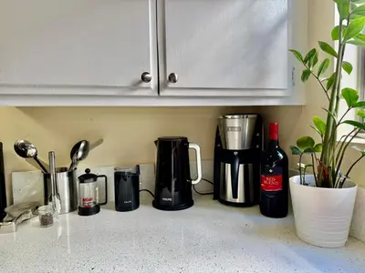 a kitchen counter with a coffee maker and a bottle of wine at Proper Stays at Melrose - West Hollywood Premium M suite in Los Angeles