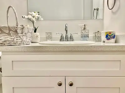a white bathroom counter with a sink and a mirror at Proper Stays at Melrose - West Hollywood Premium M suite in Los Angeles