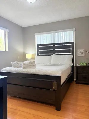 a large bed in a bedroom with a large window at Proper Stays at Melrose - West Hollywood Premium M suite in Los Angeles