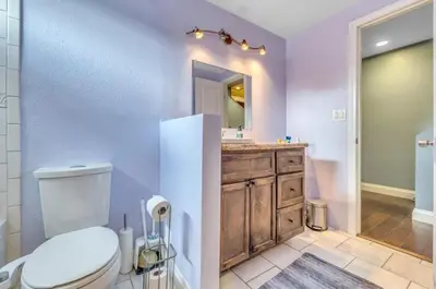 a bathroom with a toilet and a sink and a mirror at 2 Bed Apartment with Private Terrace Near SoFi in Los Angeles