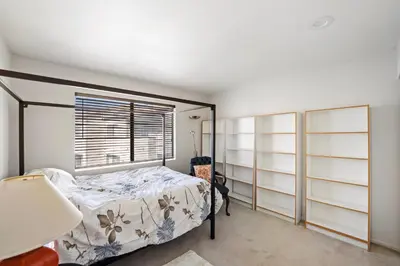a bedroom with a bed and a window at Elsa House in Warner Center Plaza One Heliport