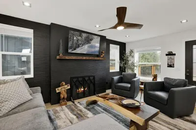a living room with a couch and a fireplace at Stairway to Heaven at Big Bear- Million Dollar Lake Views - Modern Luxury Chalet w/ Hot Tub in Big Bear Lake