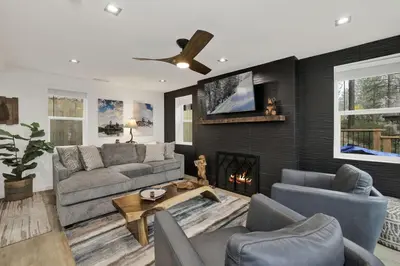 a living room with a couch and a fireplace at Stairway to Heaven at Big Bear- Million Dollar Lake Views - Modern Luxury Chalet w/ Hot Tub in Big Bear Lake