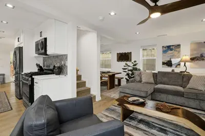 a living room with a couch and a table at Stairway to Heaven at Big Bear- Million Dollar Lake Views - Modern Luxury Chalet w/ Hot Tub in Big Bear Lake