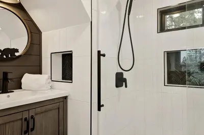 a bathroom with a shower and a sink at Stairway to Heaven at Big Bear- Million Dollar Lake Views - Modern Luxury Chalet w/ Hot Tub in Big Bear Lake