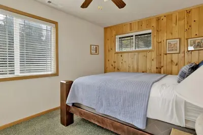 a bedroom with a bed and two windows at Brownie Retreat Walk-to-Summit Mountain Getaway for Snowboarders & Skiers in Big Bear Lake