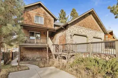 a brick house with a balcony and a garage at Brownie Retreat Walk-to-Summit Mountain Getaway for Snowboarders & Skiers in Big Bear Lake